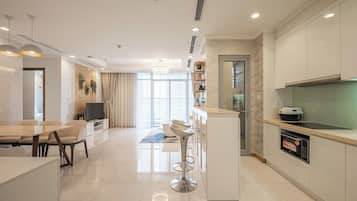 Family Apartment, 3 Bedrooms, Balcony | Living area | 42-inch flat-screen TV with digital channels