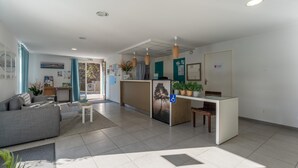 A modern reception area with a reception desk, seating, and a view of the outdoors. - Lacanau Stay, 100m to Lake & Pool (Lacanau)