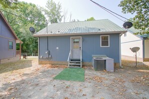 A small, single-story building with a metal roof, a front door, and a small porch. - Lake & Dock Access! Waterfront Hot Springs Haven (Hot Springs)