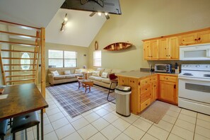 A kitchen with wooden cabinets, a stove, and a microwave. - Lake & Dock Access! Waterfront Hot Springs Haven (Hot Springs)