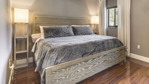 A bedroom with a bed, bedside tables, a window with curtains, and a nightstand. - Walk to Water! Boynton Beach Gem w/ Backyard Oasis (Boynton Beach)