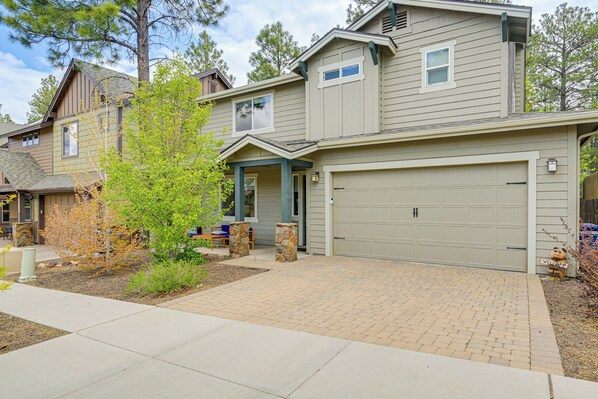 A residential house with a garage, a front porch, and a brick driveway. - 3 Mi to Dtwn! New Family Friendly Flag Getaway (Flagstaff)
