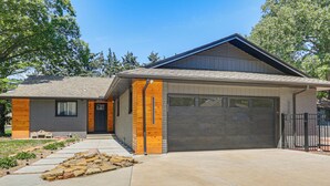A modern two-story house with a garage, a stone pathway, and a well-maintained lawn. - Great for Youth Sports Trips! Roomy Goddard Home (Goddard)