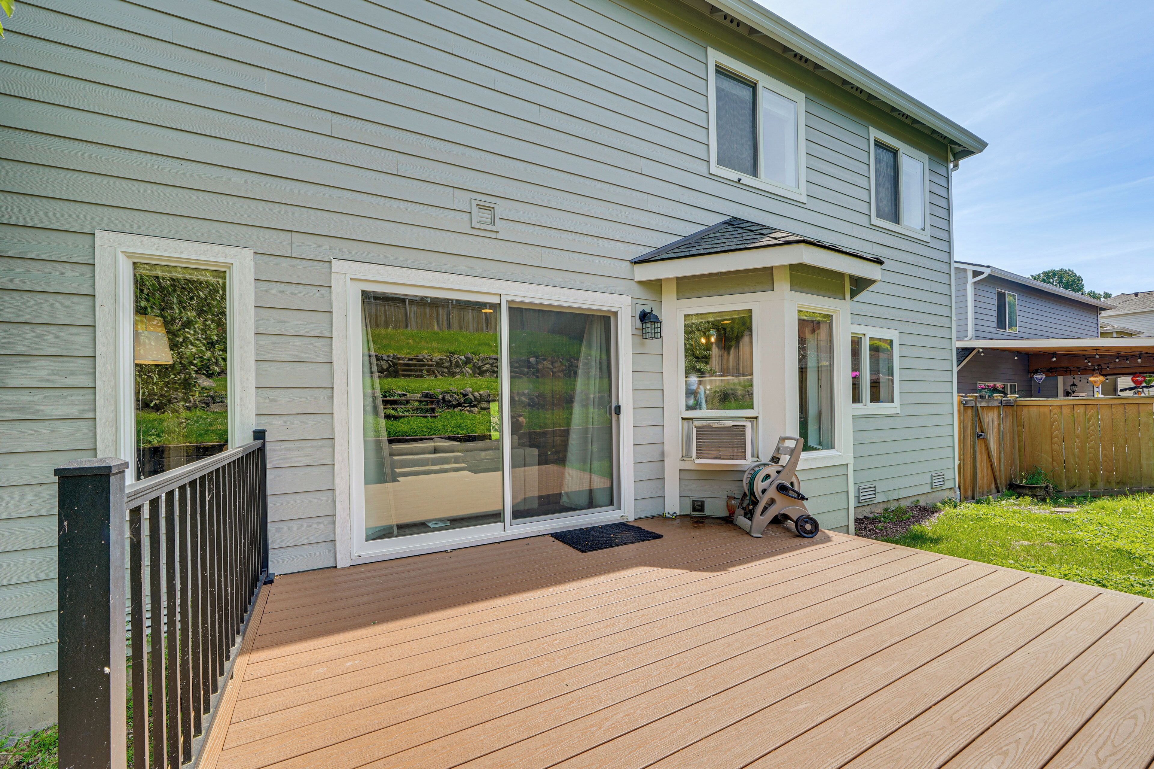 A house with a deck, a sliding glass door, and a small porch.