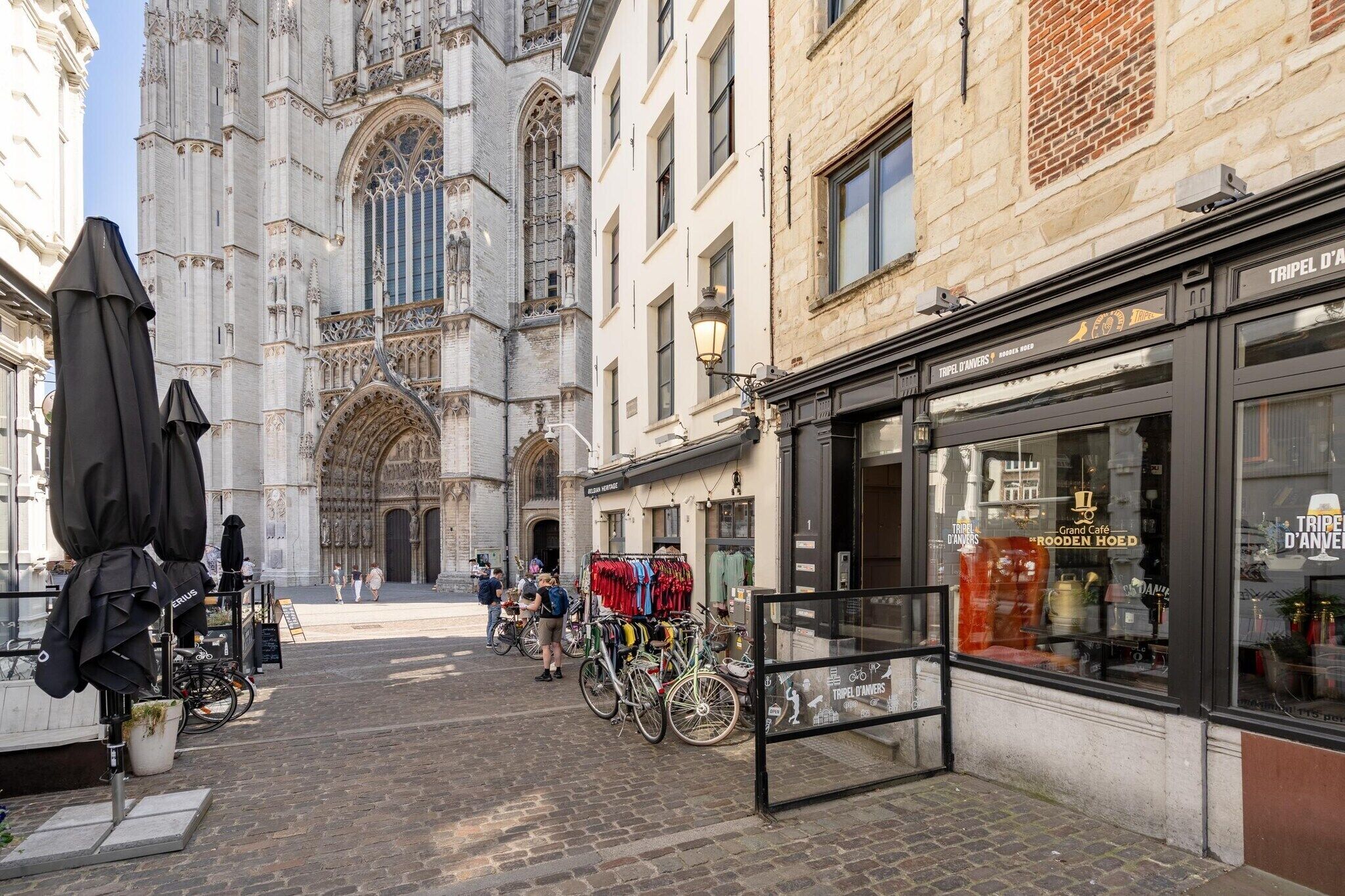 A street with a historic church, a café, and bicycles.