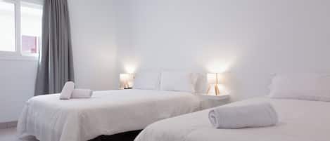 Triple Room | Blackout drapes, iron/ironing board, free WiFi, bed sheets