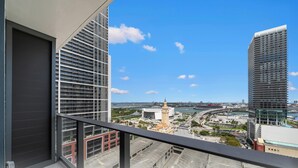 A high-rise building with a view of a river and a bridge. - 501 First Studio with Luxury Amenities (Miami)