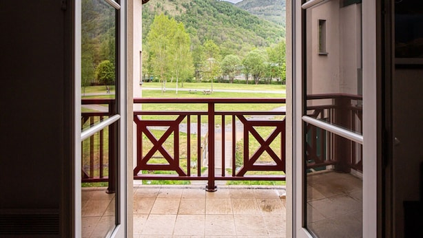 A balcony with a view of a green landscape and hills. - Functional Alpine Base for 8 Guests (Loudenvielle)