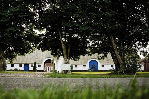 Un edificio bianco con una porta blu e un cartello con la scritta 'Welcome'.