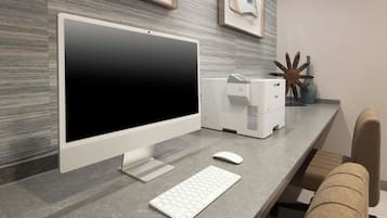 A modern office desk with a desktop computer, keyboard, and mouse.