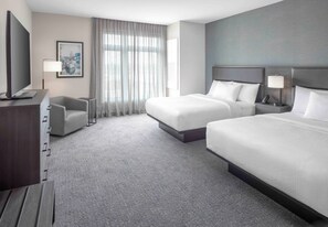A hotel room with two beds, a desk, a chair, a television, and a window with curtains. - Residence Inn by Marriott Portland Thompson's Point (Portland)