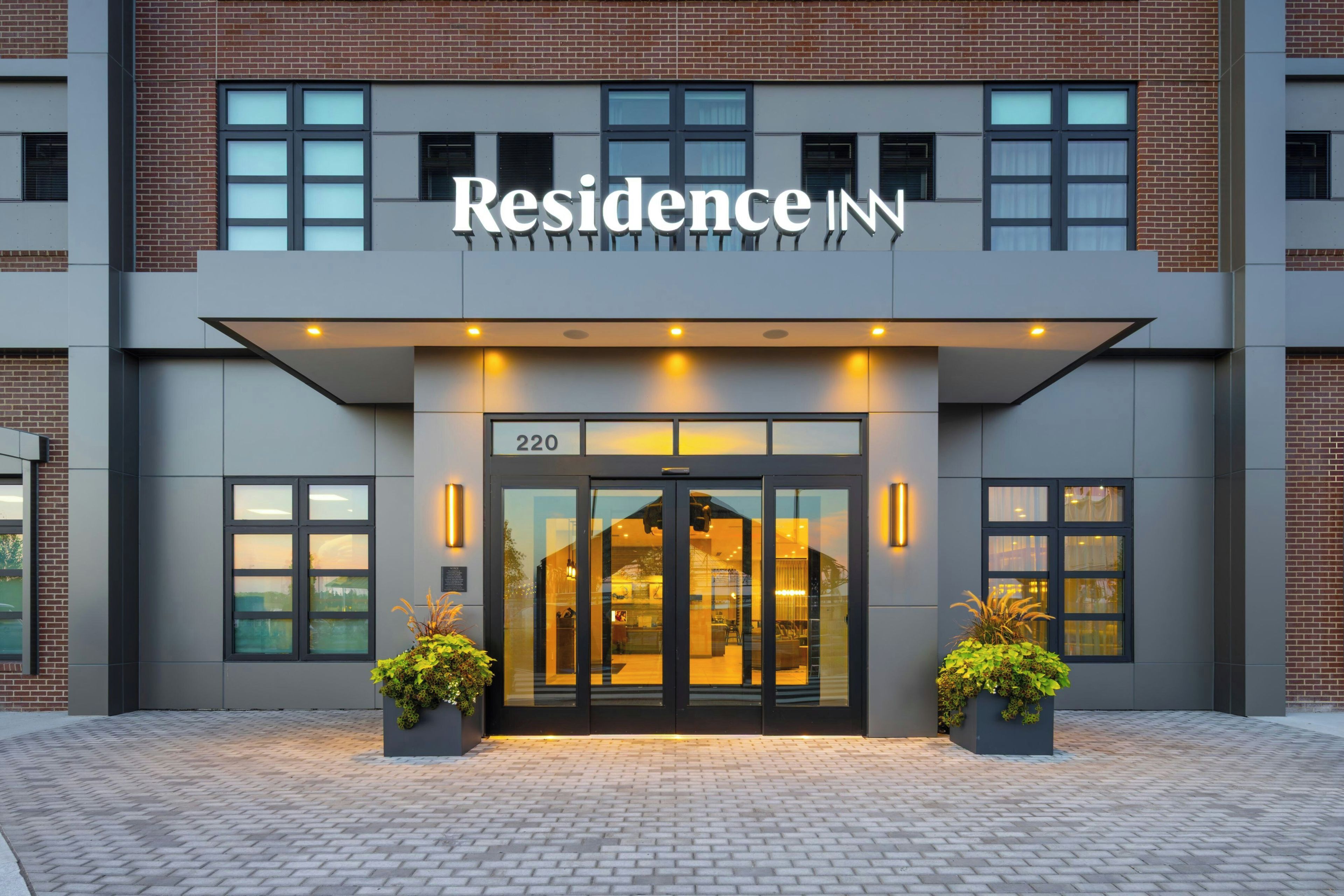 A modern building with a sign reading 'Residence Inn' above the entrance.
