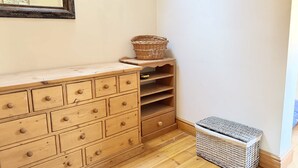 A wooden dresser with drawers, a wicker basket, and a wicker basket on a shelf. - The Boat Hole - Riverside Living in Cambridge (Cambridge)