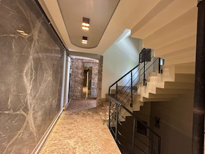 A modern interior with a marble floor, a staircase with metal railings, and recessed lighting. - Diker Port Residence (11)Furnished, 5 Min to Beach (Konyaaltı)