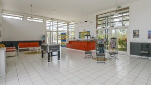 A spacious lobby with a reception desk, seating area, and large windows. - Spacious Provence House for Eight (Saint-Saturnin-les-Avignon)