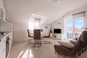 A modern apartment with a kitchen, dining area, living room, and balcony. - Batur Pool Apartments (Zadar)