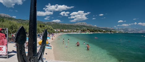 Beach nearby, white sand, beach towels