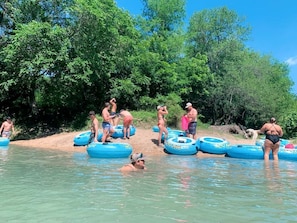 People in a natural setting with water and trees.