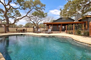 A clear swimming pool with lounge chairs and a covered patio area. - Luxurious German-Style Ranch Vacation Rental with Pool Access and Stunning Views in Bergheim, Texas (Bergheim)