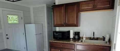 Fridge, microwave, coffee/tea maker, cookware/dishes/utensils
