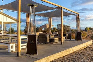 An outdoor patio with a pergola, seating area, and a grill station. - Heavenly Vacation Retreat with Sweeping Vineyard Views near Paso Robles Wineries in California (Paso Robles)