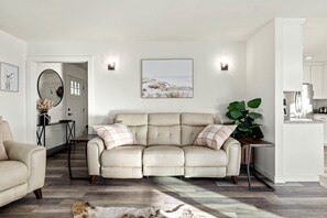 A living room with a beige sofa, a dining table, and a kitchen area. - Heavenly Vacation Retreat with Sweeping Vineyard Views near Paso Robles Wineries in California (Paso Robles)
