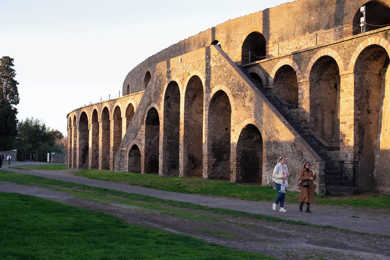 A historic stone building with multiple arches and a staircase.