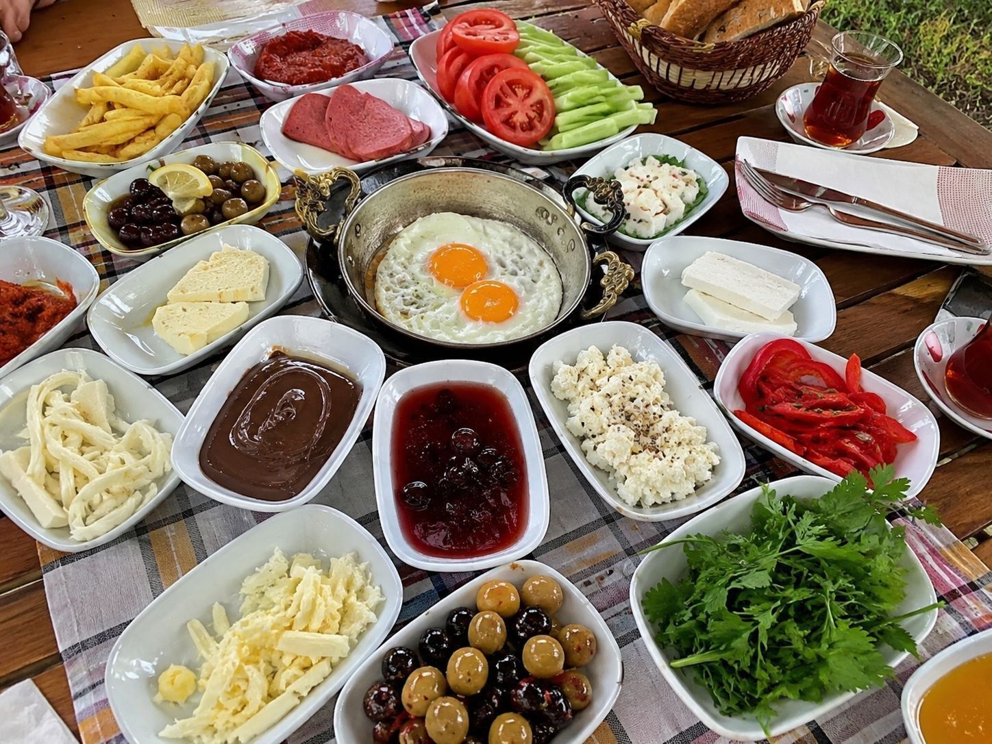 A table with various food items including eggs, cheese, olives, and bread.