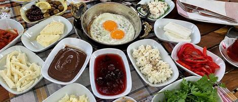 A table with various food items including eggs, cheese, olives, and bread.