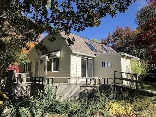 A single-story house with a front porch, a garage, and a small attached shed.