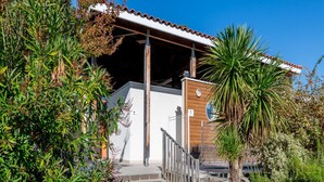 A building with a covered entrance, steps leading up to it, and surrounding greenery. - Nature Stay Near Biscarrosse Lake (Parentis-en-Born)
