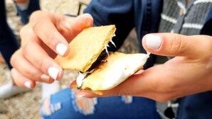 A person holding a grilled sandwich. - Texas Glamping: Tranquil Safari Tent Vacation by the San Marcos River near Kingsbury (Kingsbury)