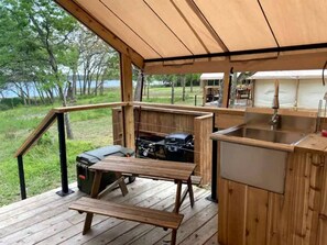 Outdoor dining - Peaceful Lakefront Safari Tent with Fire Pit and Lake Views near Austin, Texas (Bastrop)