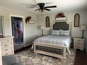 A bedroom with a bed, a ceiling fan, a dresser, and a nightstand. - Charming Vacation Rental near Owensville, Missouri - Ideal for a Glamping Retreat with Family and Friends (Boulware Township)
