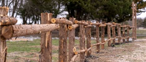 A wooden fence made of logs and branches.