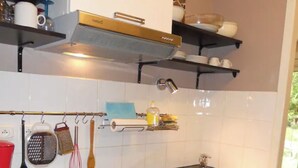 A compact kitchen with white cabinets, a black countertop, a stainless steel sink, and a dishwasher. - 🌿Cosy studio with 4 bedrooms and private terrace not overlooked 10min from beaches (Anglet)