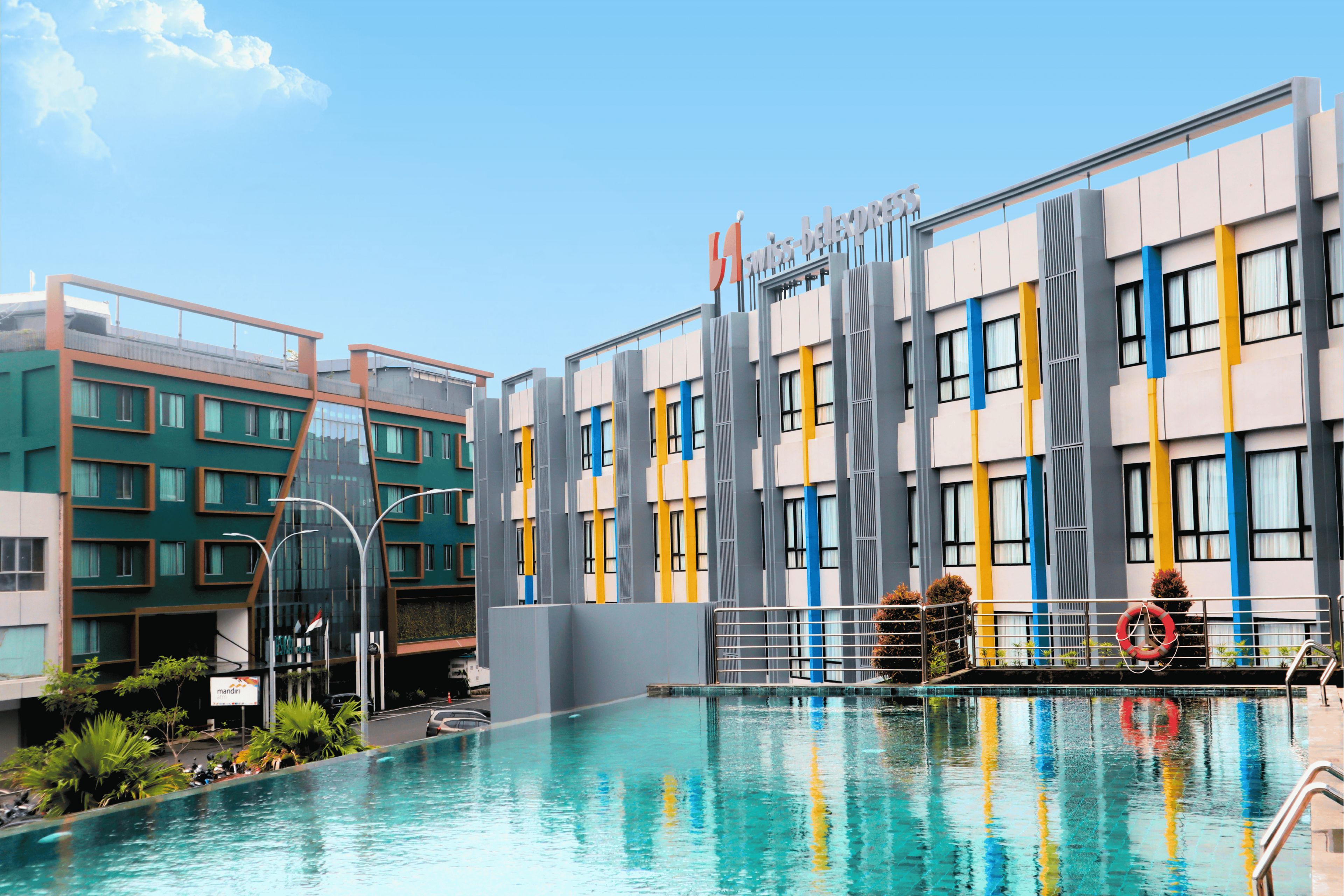 A swimming pool with a modern building in the background.