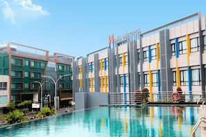 A swimming pool with a modern building in the background.