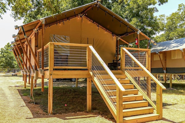 A wooden structure with a ramp and a fenced area, likely a birdhouse or similar.