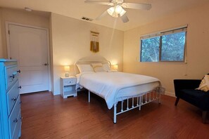 A bedroom with a bed, a nightstand, a dresser, a ceiling fan, and a window. - Mountain Family Cottage Ideal for Outdoor Adventures in Ohio (Wishon)