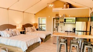 A tented accommodation with two beds, a kitchenette, and a bar area. - #3 Waterfront Cabin - Cibolo, TX (Cibolo)