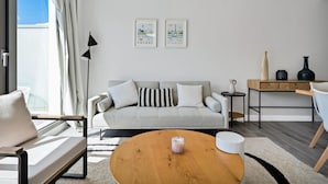A modern living room with a sofa, a coffee table, a side table, and artwork on the wall. - Modern apartment with terrace - ? guests (Mijas)