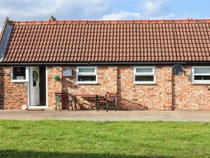 A brick building with a tiled roof, a door, and windows. - Lamb Cottage (Billingham)