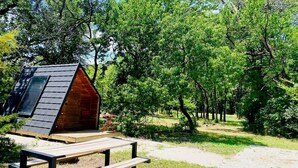 A wooden cabin with a sloped roof, a picnic table, and a gravel path. - Charming A-Frame Cabin Experience with Campfire Vibes in Humboldt, Kansas (Humboldt)