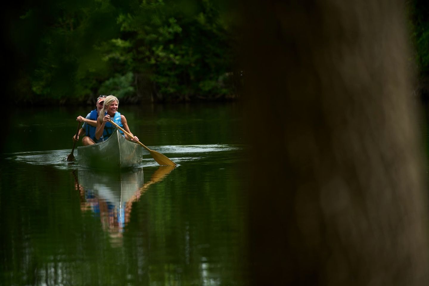 A person in a canoe on a body of water.