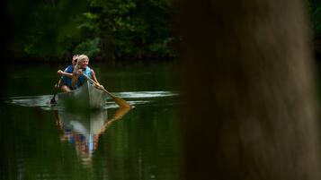 A person in a canoe on a body of water.