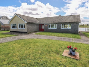 A two-story building with a red door, multiple windows, and a paved driveway. - Sweetbriar Lodge (Loughglinn)
