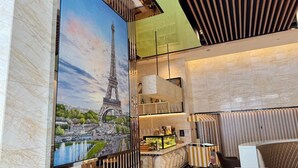 A modern interior with a large mural of the Eiffel Tower, a bar area with shelves, and a seating area with a striped pattern. - kl city center klcc by dome (Kuala Lumpur)