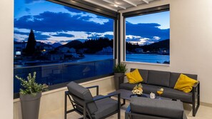 A balcony with a sofa, chairs, a small table, and a potted plant. - Villa Sunset Blace by Villas Guide (Blace)