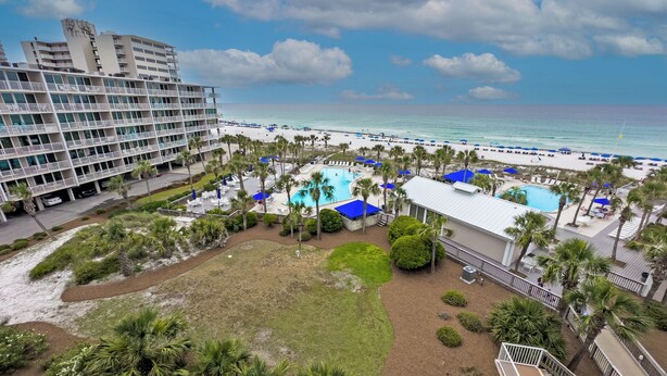 A hotel with a pool area, beach access, and a view of the ocean. - Beach Time, Fun Time, All the Time B505 at the Dunes! Fantastic View (Panama City Beach)